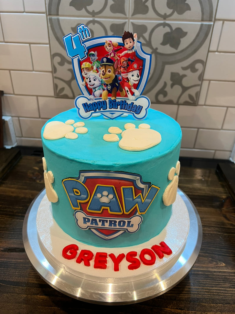  birthday cake with decorative topper on a kitchen counter.